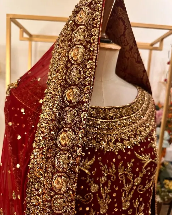 Red velvet bridal with gold zardozi neckline