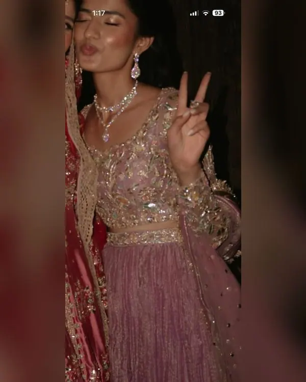 Model wearing a rose pink embellished lehenga choli